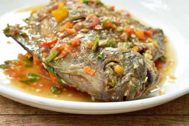 istock deep fried white pomfret dressing spicy sauce 1157143617