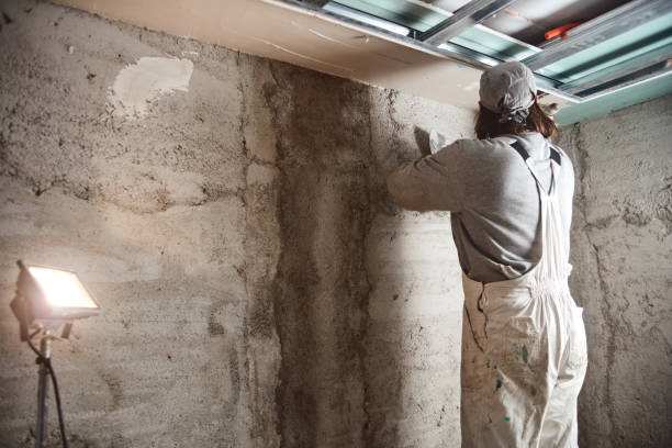 istock Construction worker plastering gypsum walls inside the house. 1157143652