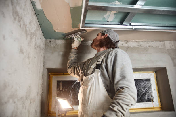 istock Construction worker plastering gypsum walls inside the house. 1157143672