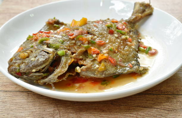 istock deep fried white pomfret dressing spicy sauce 1157143777
