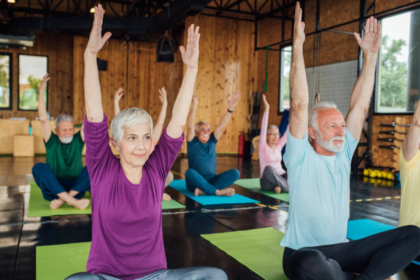 istock Old people exercising yoga 1157155121