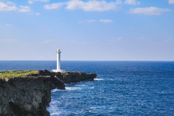 istock white lighthouse in cape zanpa with blue sea and sky 1157155655