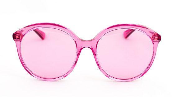 Pink sun glasses on white background side view