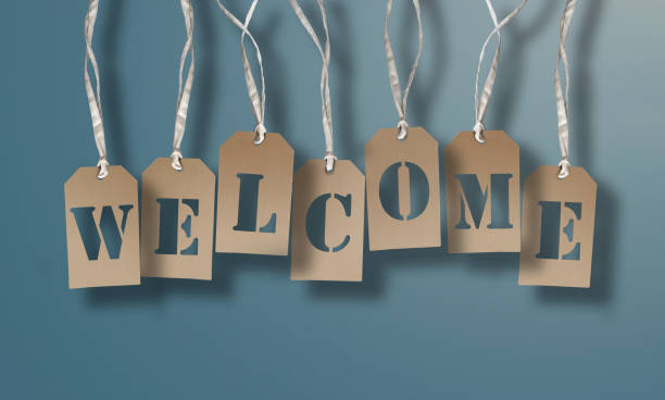 istock WELCOME on brown hang tags or cardboard labels against light blue background 1157158030