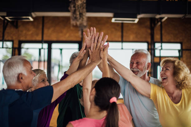 istock Fit senior people giving each other high five 1157158189
