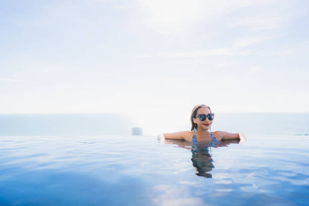 istock Woman Swimming In Infinity Pool 1157158265