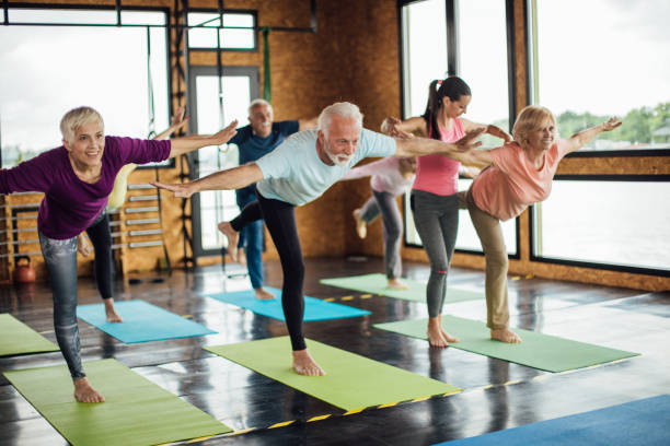 istock People exercising yoga together 1157158973