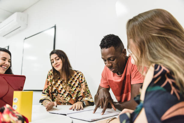 istock Group of a college students while working together in classroom 1157159417