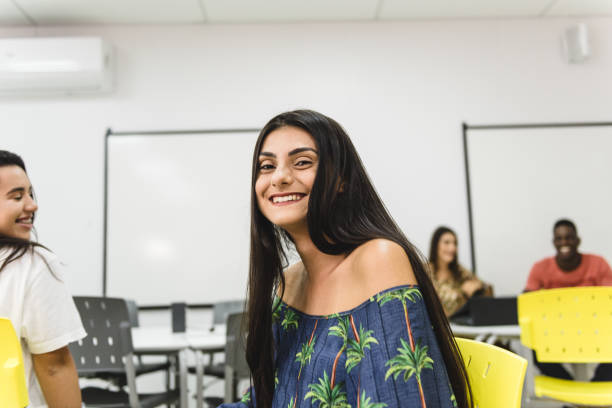istock Young college student woman smiling in classroom 1157159426