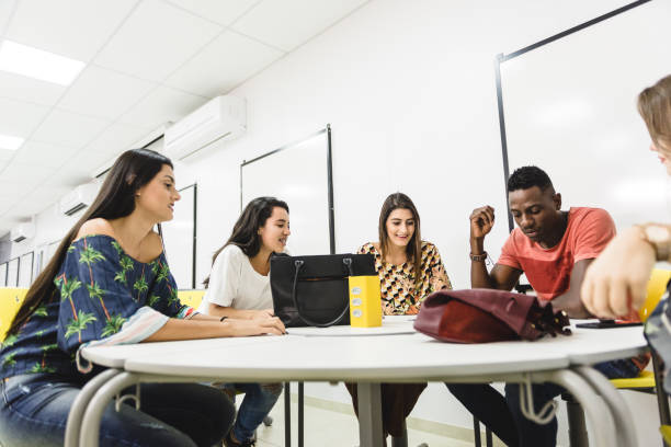 istock Group of a college students while working together in classroom 1157159444