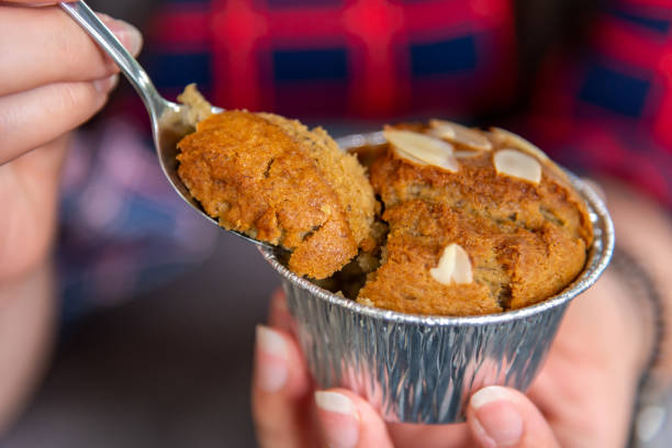 istock Hand women with banana cupcake in spoon 1157164261