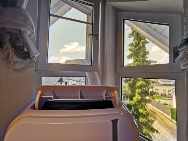 Mobile air conditioning being used at attic flat during massive heat period