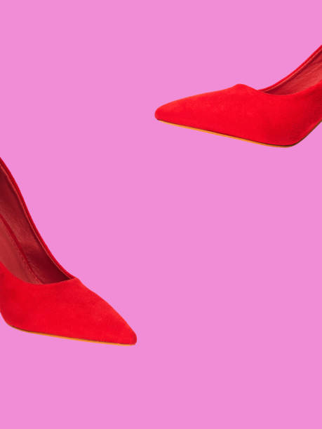 istock Red female pumps isolated on pink 1157164660