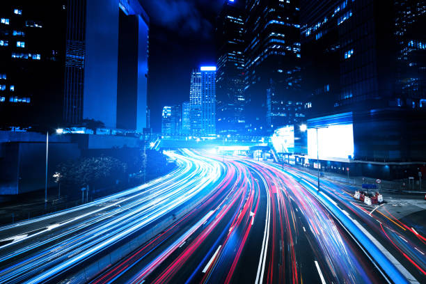 istock Moving car with blur light through city at night 1157167643
