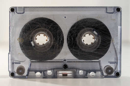standing clear old retro cassette tape with tape wound half way