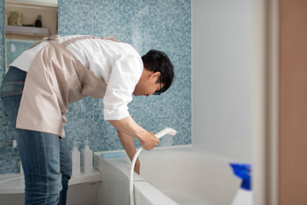 istock Stay-at-home-father cleaning in bath room 1157175280
