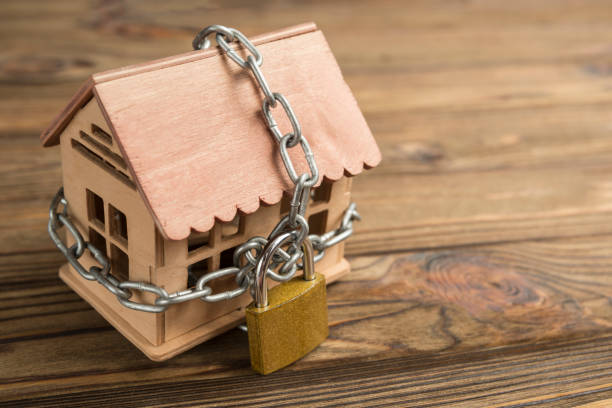 istock House closed on a lock with a chain. 1157175625