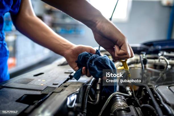 Checking Oil In Car Engine Stock Photo - Download Image Now - Car, Auto Repair Shop, Mechanic