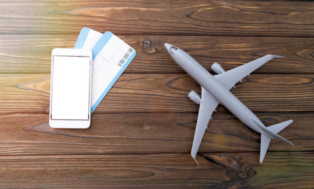 istock Smartphone, tickets, plane on a wooden background. 1157179655