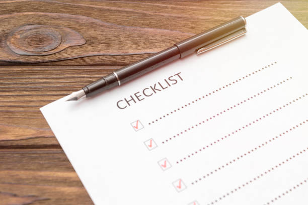 istock checklist, fountain pen on a wooden background. 1157179713