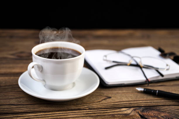 istock Notepad with pen, glasses, coffee on the table. 1157179839