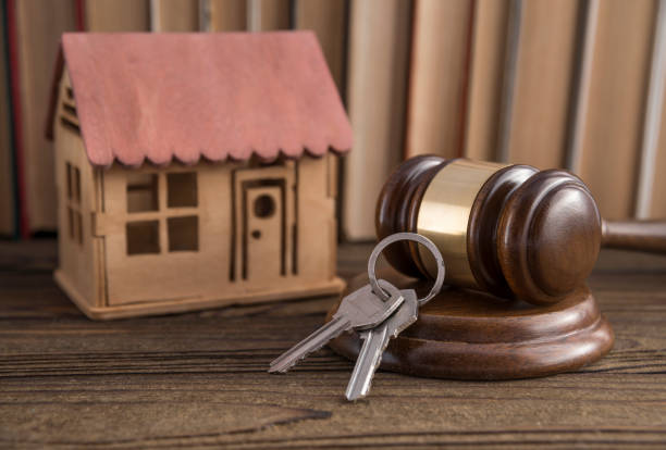House, key, judge hammer on a books background.