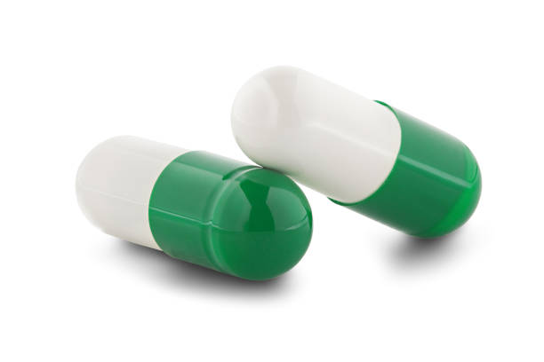 istock Two medical pills on white isolated background with shadow. 1157181336