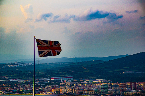 English flag waving on the blue sky of Gibraltar