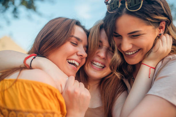 istock Friends hugging and smiling 1157183315