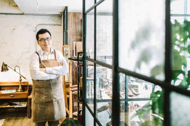 istock Male owner looking through window from shop 1157189756