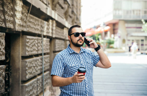 istock man using phone in the street 1157190520