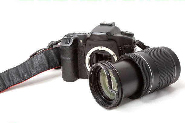 istock Broken digital SLR camera, dented protective filter on the zoom lens. Will be repaired. Isolated on white background. Side view 1157191292