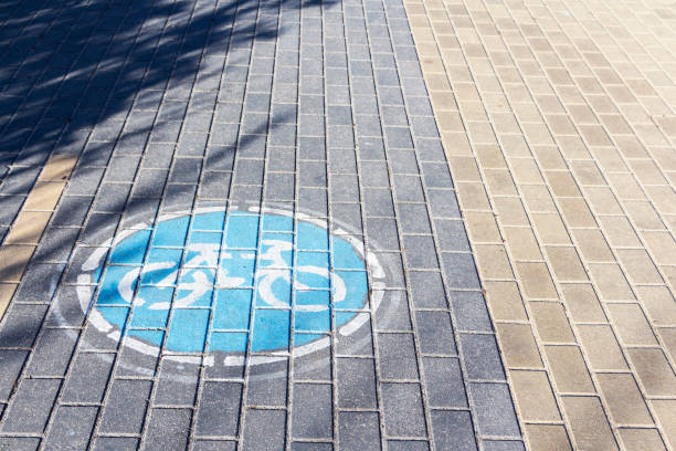 istock sign Bicycle path on the paving slabs in the Park 1157192161