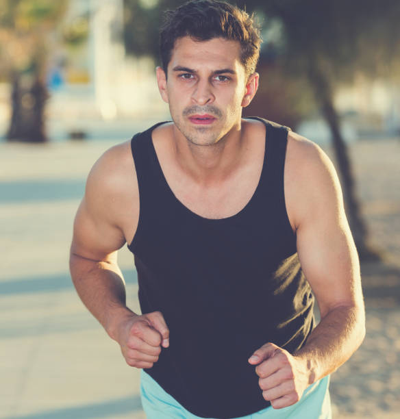 istock Man jogging on city seafront 1157196718