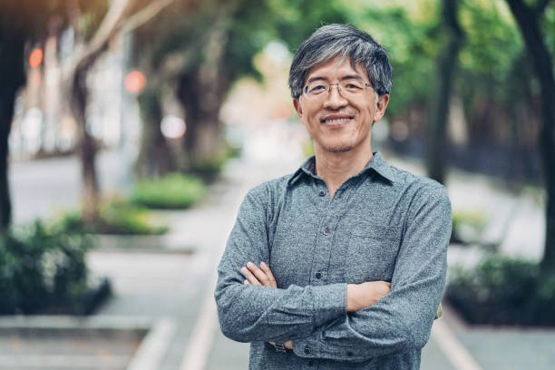 istock Mid age Chinese ethnicity man in the park 1157198912