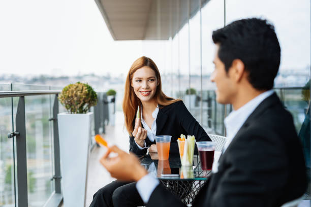istock Millennial coworkers taking a break at work and eating light snack. 1157200306