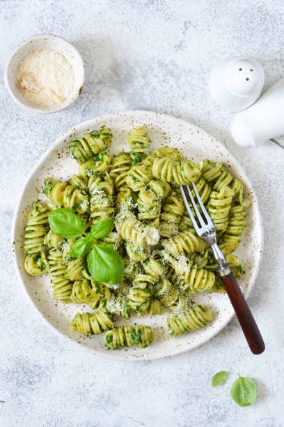 istock Pasta with pesto and parmesan on a concrete background. View from above. 1157201787