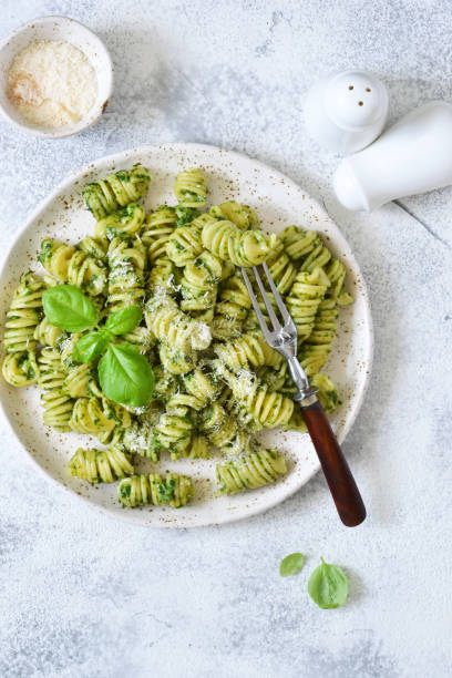 istock Pasta with pesto and parmesan on a concrete background. View from above. 1157201804