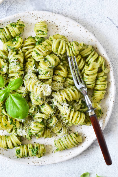 istock Vegan pasta with spinach, basil and parmesan. Lunch on the kitchen table. 1157201844