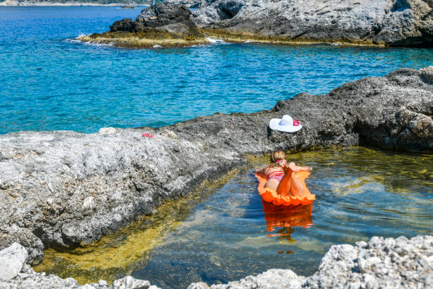 Sunbathing in the bay. Women is sunbathing on the seabed