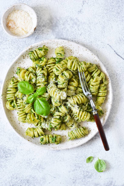 istock Vegan pasta with spinach, basil and parmesan. Lunch on the kitchen table. 1157201914