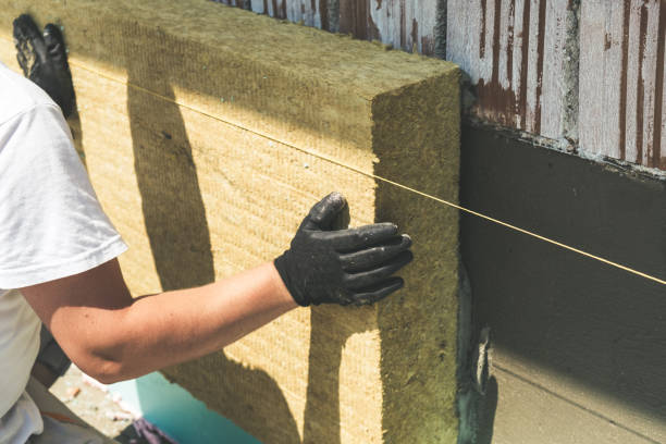 Worker installing rock wool panels Worker installing rock wool panels on facade wall insulation stock pictures, royalty-free photos & images