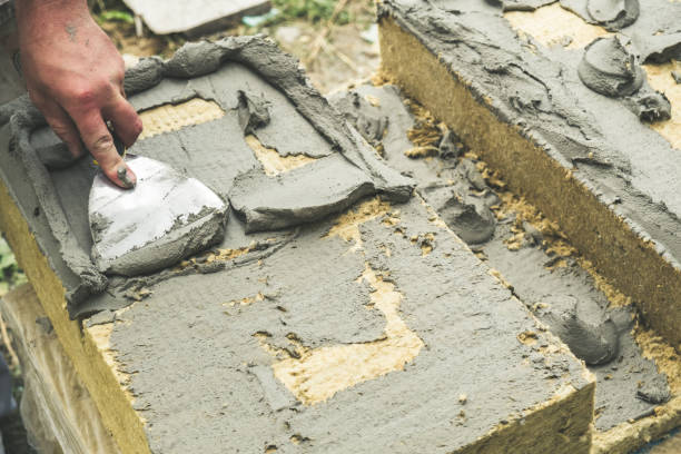 istock Worker plying adhesive on rock wool 1157202297