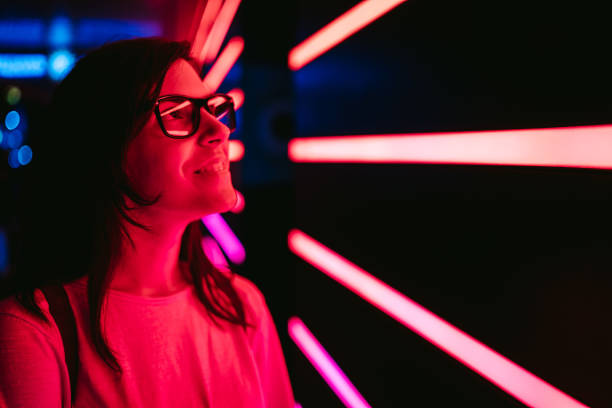 istock Curious woman and neon lights 1157202529