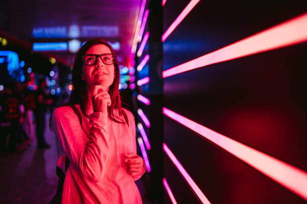 istock Pensive girl and bright neon lights 1157202582