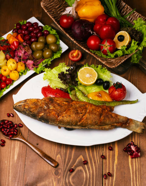 istock Roasted fried whole fish with grilled vegetables 1157203726