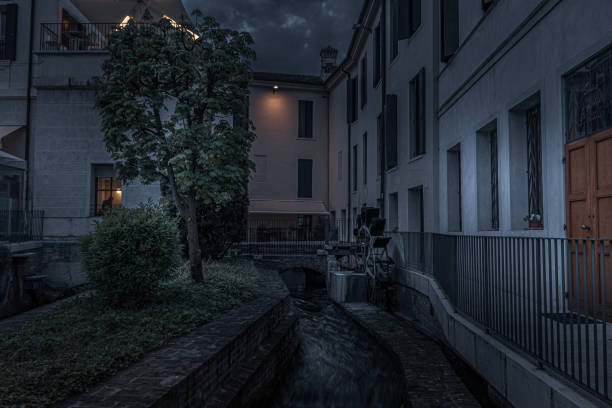 istock Fantasy night scene by the river passing through the city. 1157204471