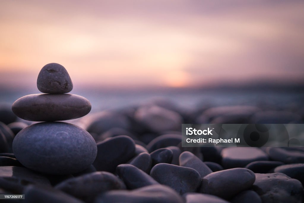 Sunset with pebbles on beach in Nice, France. Sunset on pebbles in Nice, France. Tranquility Stock Photo
