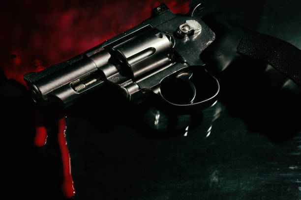 istock Revolver and blood on black 1157205923