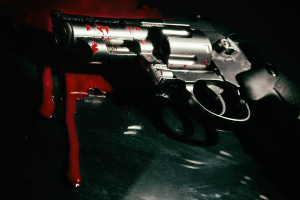 istock Revolver and blood on black 1157205934